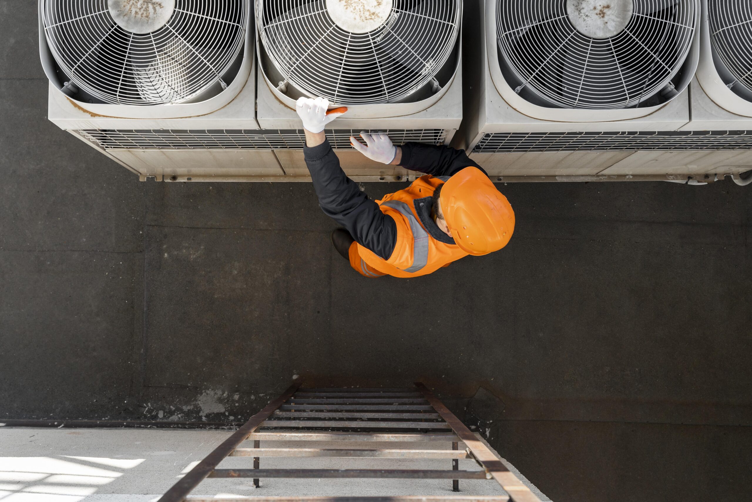 Air conditioning repair technician servicing an AC unit in Tucson Arizona
