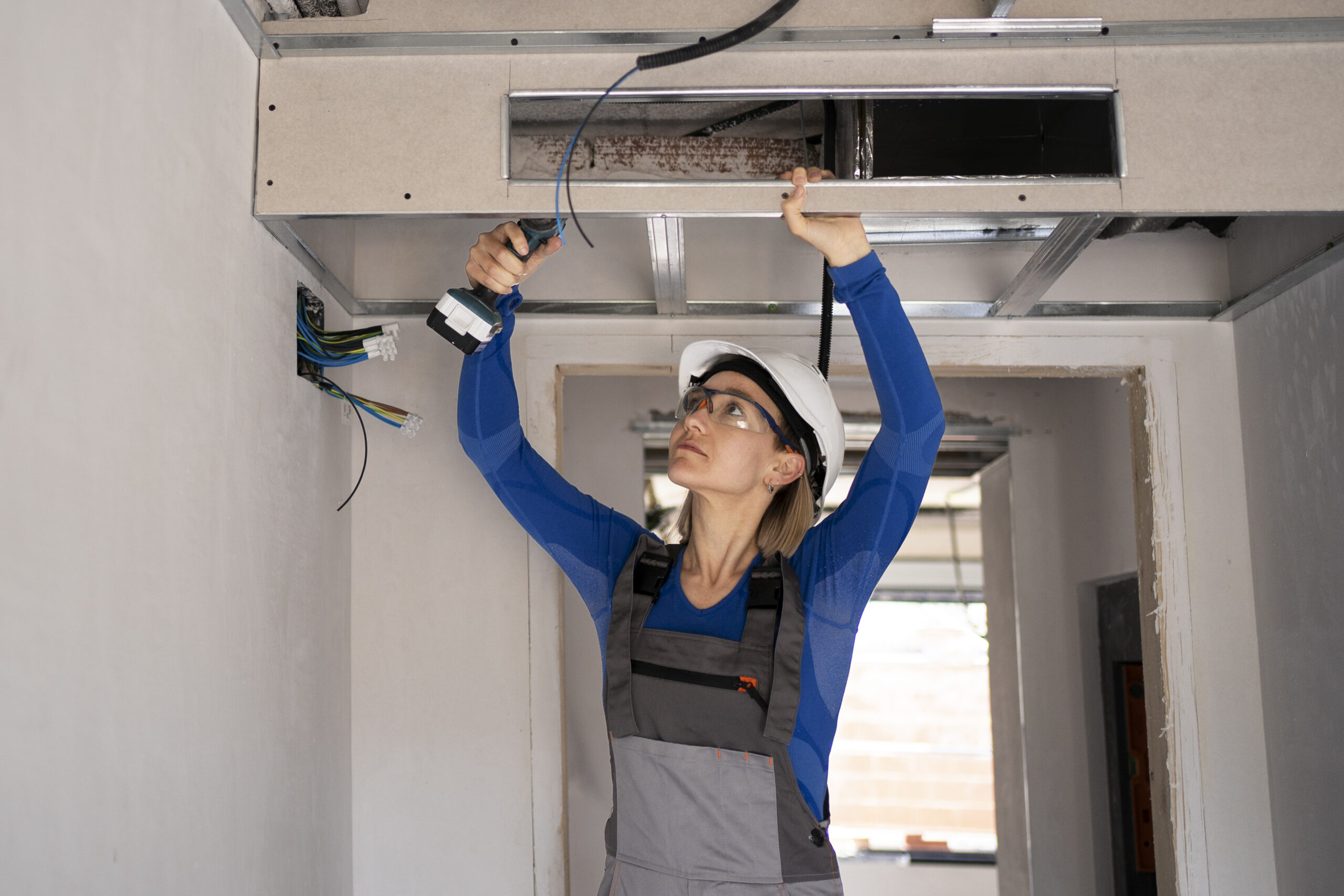 HVAC technician inspecting an air conditioning system before repair or replacement